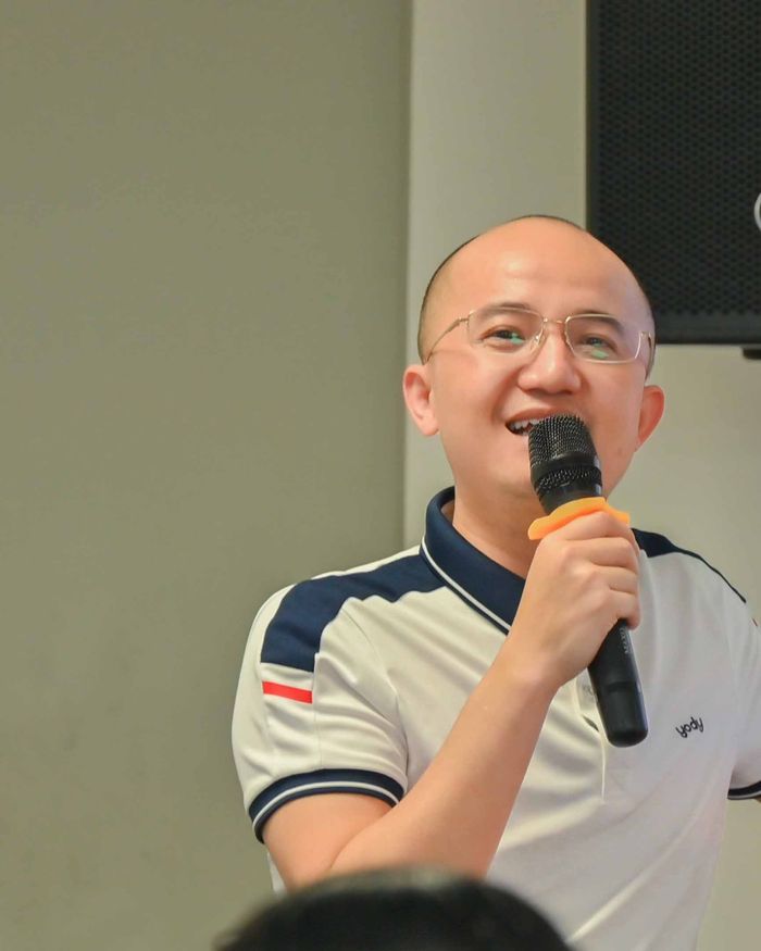 Gia Cát Duẩn cầm mic giảng bài