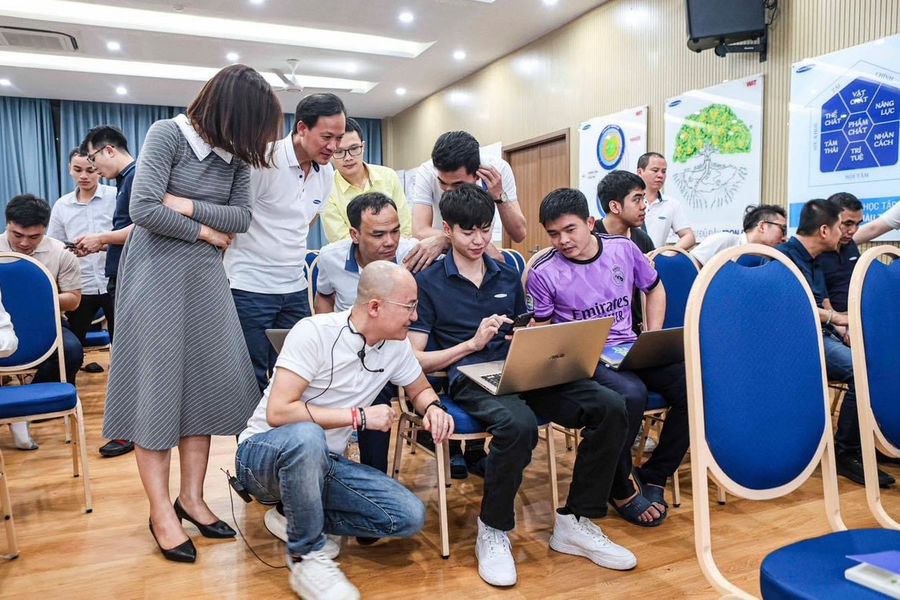 Gia Cát Duẩn ngồi kèm một nhóm học viên
